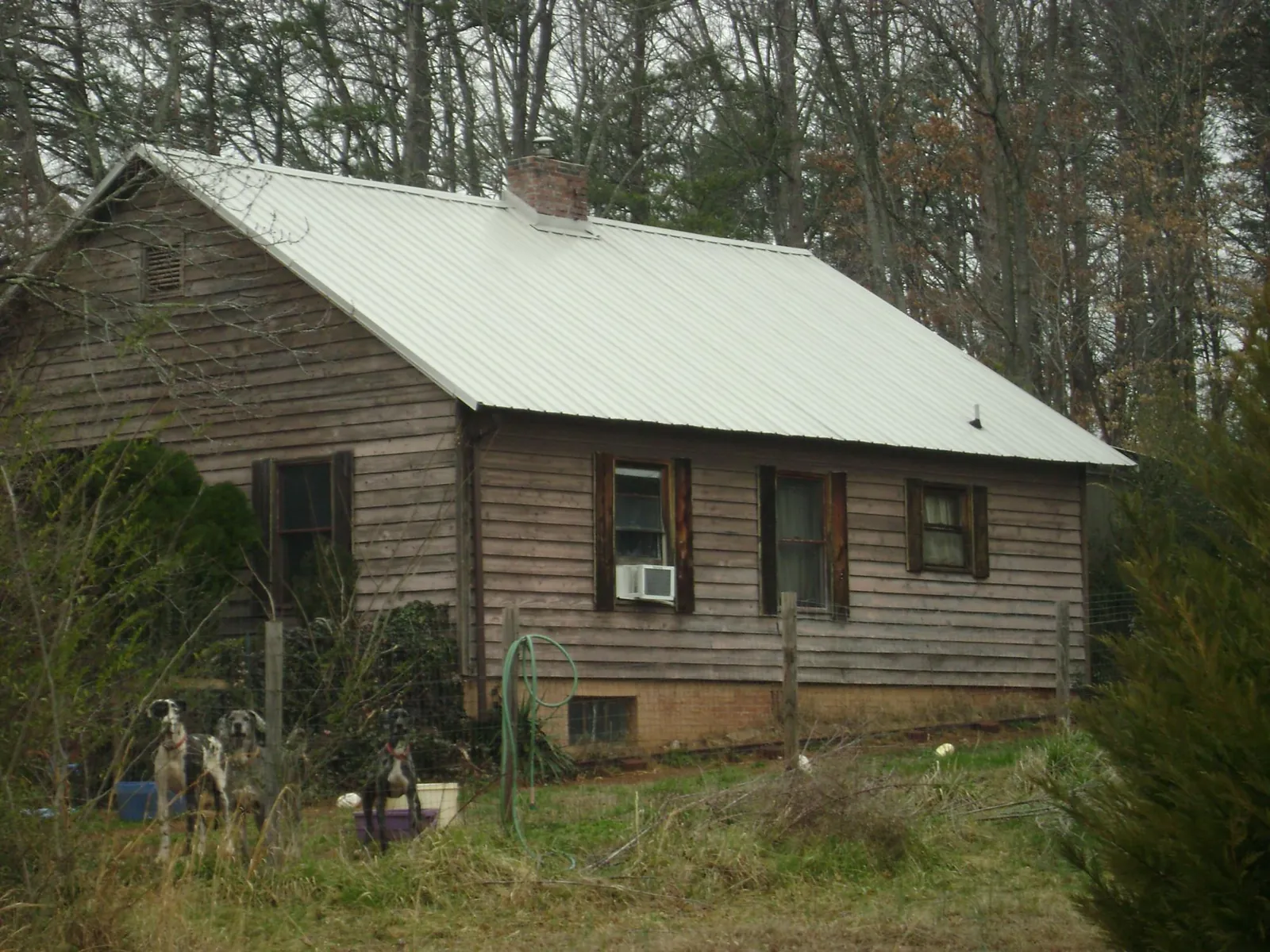 White metal roof on an old wood sided farmhouse, from a Asphalt Shingle Roof Repair job in Rootstown